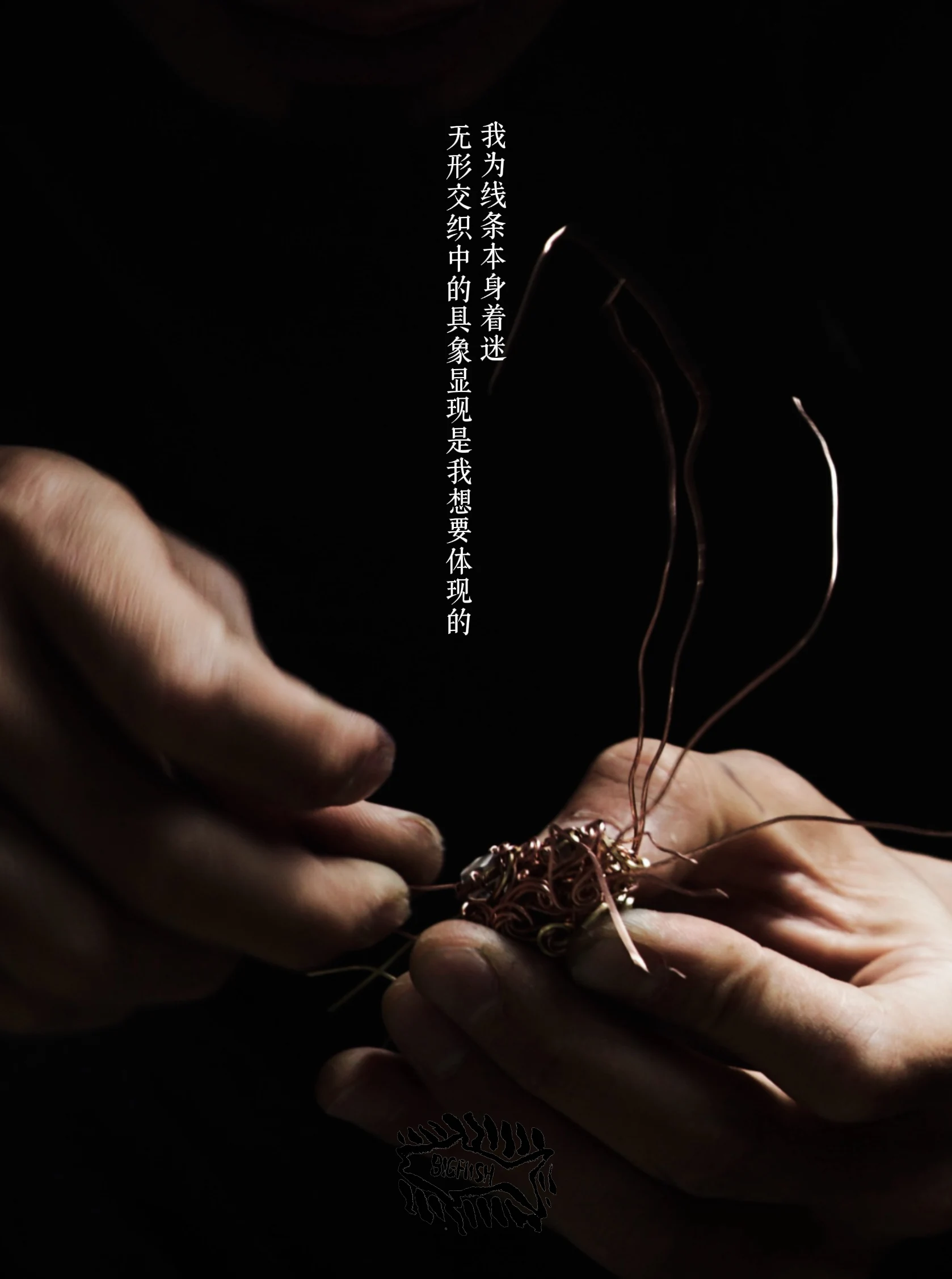 Hands working on a wire-wrapped crystal pendant
